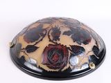 a black and white bowl with a flower design on it