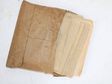 several pieces of brown paper sitting on top of a white table