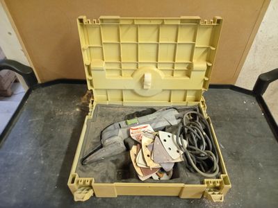 a yellow box with tools in it sitting on the floor