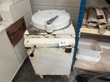 a white stove with a white lid and a metal pan on top