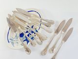 a lot of silverware on a plate on a table