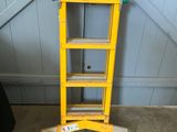 a yellow ladder that is leaning against a wall