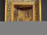 une vieille photo représentant un homme et une femme assis à une table devant une fenêtre