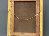 an old wooden easel with a painting on it against a gray background