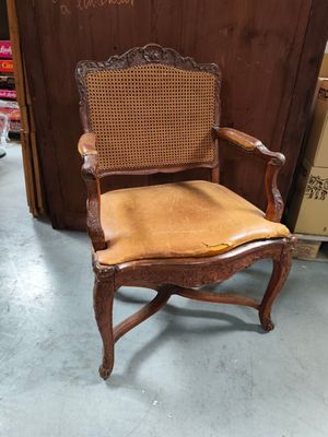 an old wooden chair with a cane back and a cane seat