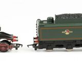 several toy trains are lined up in a row on a white surface