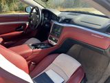 the interior of a car with a red leather seat and dashboard