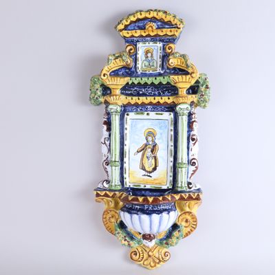 a wall clock with a painting on it on the wall