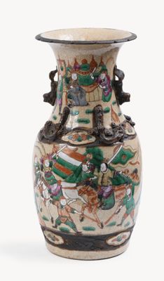 a vase with a painting on it sitting on a table