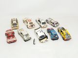 several toy cars are lined up in a row on a white surface