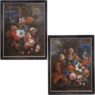 two framed paintings of flowers in a vase on a ledge