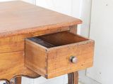 a small wooden table with a drawer on top of it