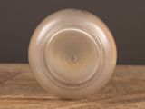 a clear glass vase sitting on a wooden table