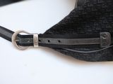 a black purse with a metal buckle on it