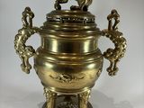 a large brass urn with two lions on it