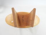 a wooden object that is sitting on a white surface