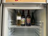 a refrigerator with a lot of bottles of wine inside of it