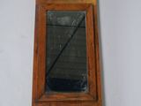 a small mirror hanging on the wall in a room