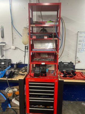 a red workbench with tools on it in a garage