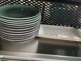 several plates stacked on top of each other in a kitchen sink
