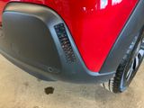 a close up of a red car ' s bumper