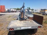 a truck with a fork on the back of it in a field