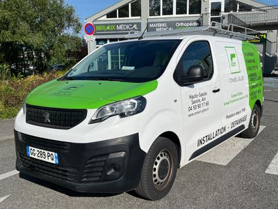 a green and white van parked in front of a building