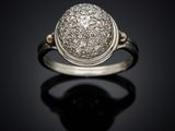 a close up of a diamond ring on a black surface