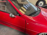a red car that is parked in a parking lot