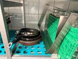 pots and pans are sitting on a shelf in a kitchen