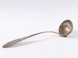 a spoon that is sitting on a white surface