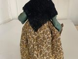 figurine of a woman with a black shawl and a cane