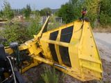 a yellow bulldozer sitting on the side of the road