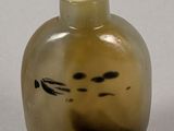 an image of a glass bottle with a cat face on it