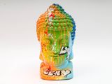 a colorful statue of a buddha head on a white surface