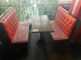 two benches and a table in the corner of a restaurant