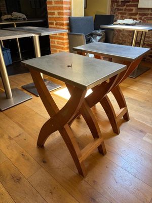two tables that are sitting on a wooden floor