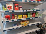 many different types of teas on the shelves in the store