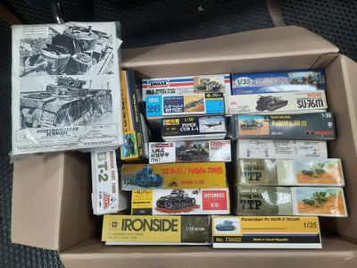 a cardboard box filled with assorted toys and books