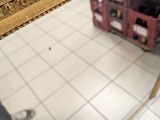 a skateboard that is sitting on the floor in front of a mirror
