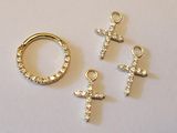 three pieces of gold and diamond jewelry on a white surface