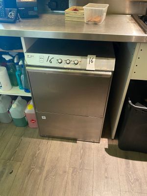 a small kitchen with a stove, dishwasher, and a microwave