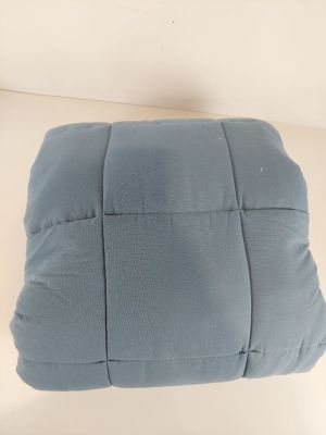 the cushion is blue and has a small square design on it