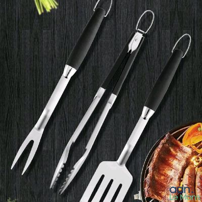 a set of 4 stainless steel barbecue utensils with black handles