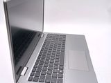 a silver laptop with a black keyboard on a white surface