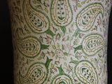 a close up of a vase with a paisley pattern on it