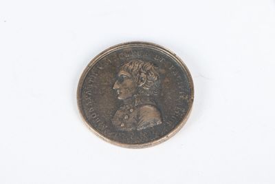 an old coin with a woman ' s face on it on a white surface