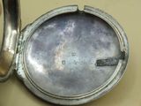 a small silver box with a silver lid on a table