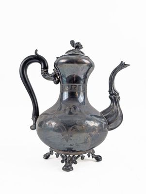 a silver tea pot on a stand on a white background