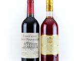 two bottles of wine sitting next to each other on a white surface